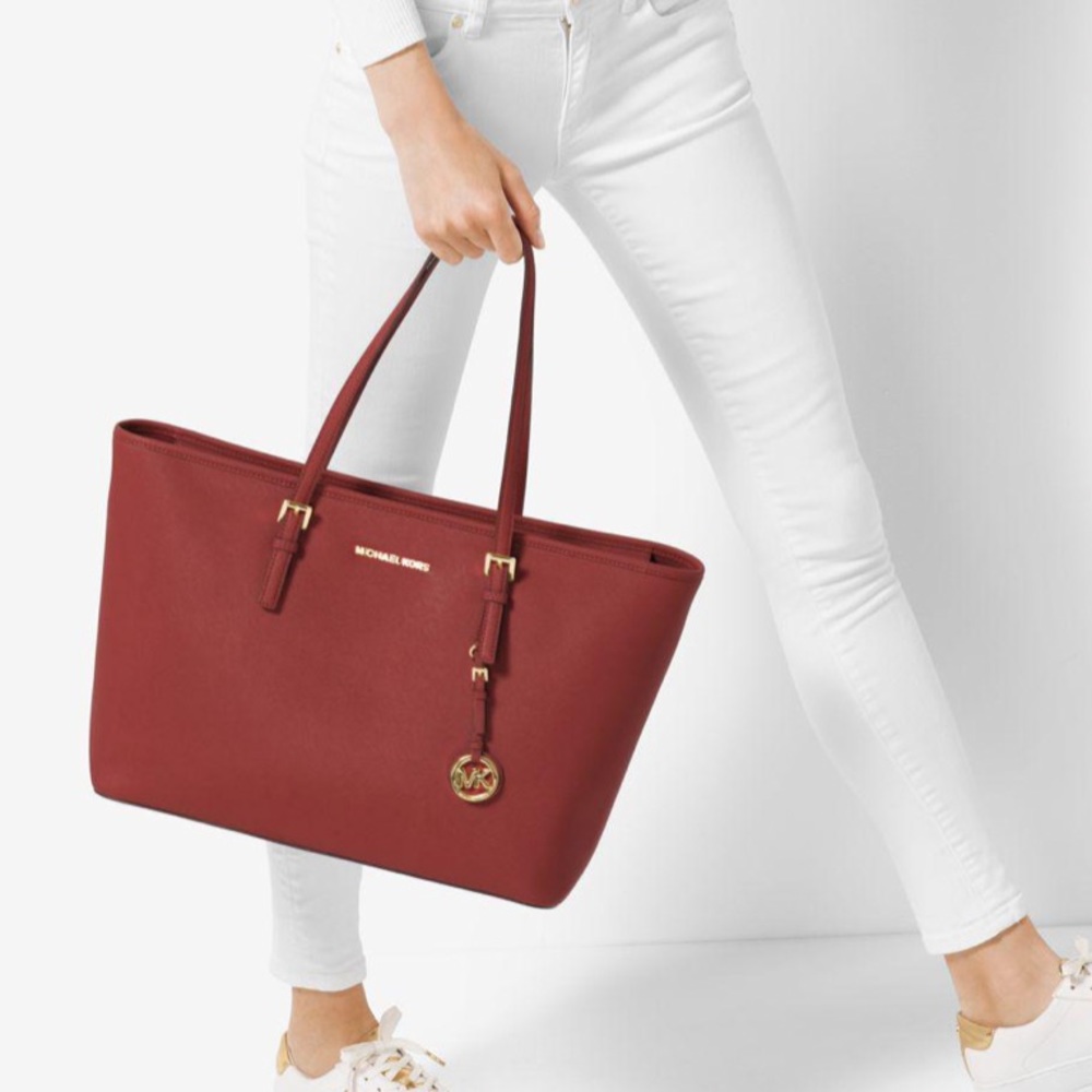 NWOT Michael Kors deep red jet setter staffaino leather tote with silver.